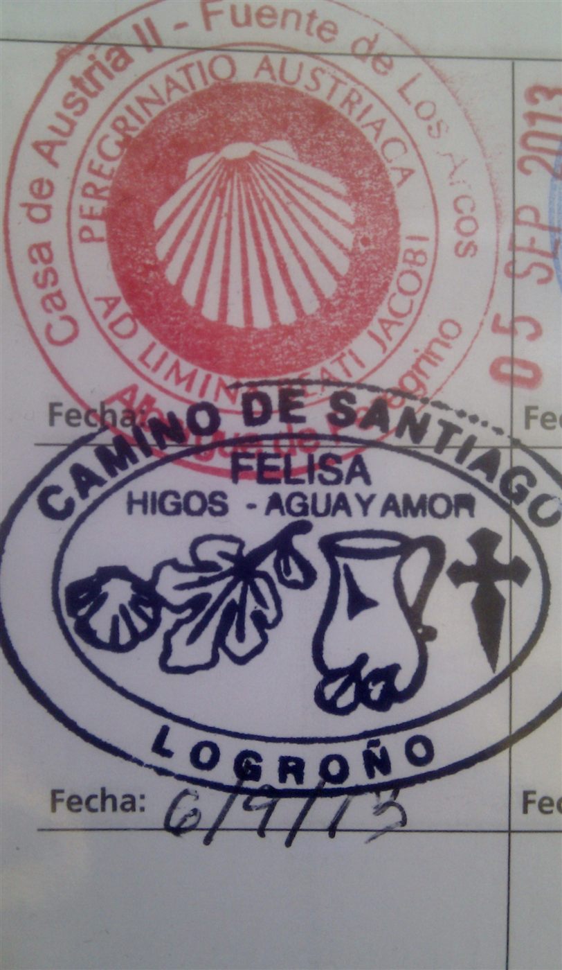 A pilgrim credential with Camino stamps.